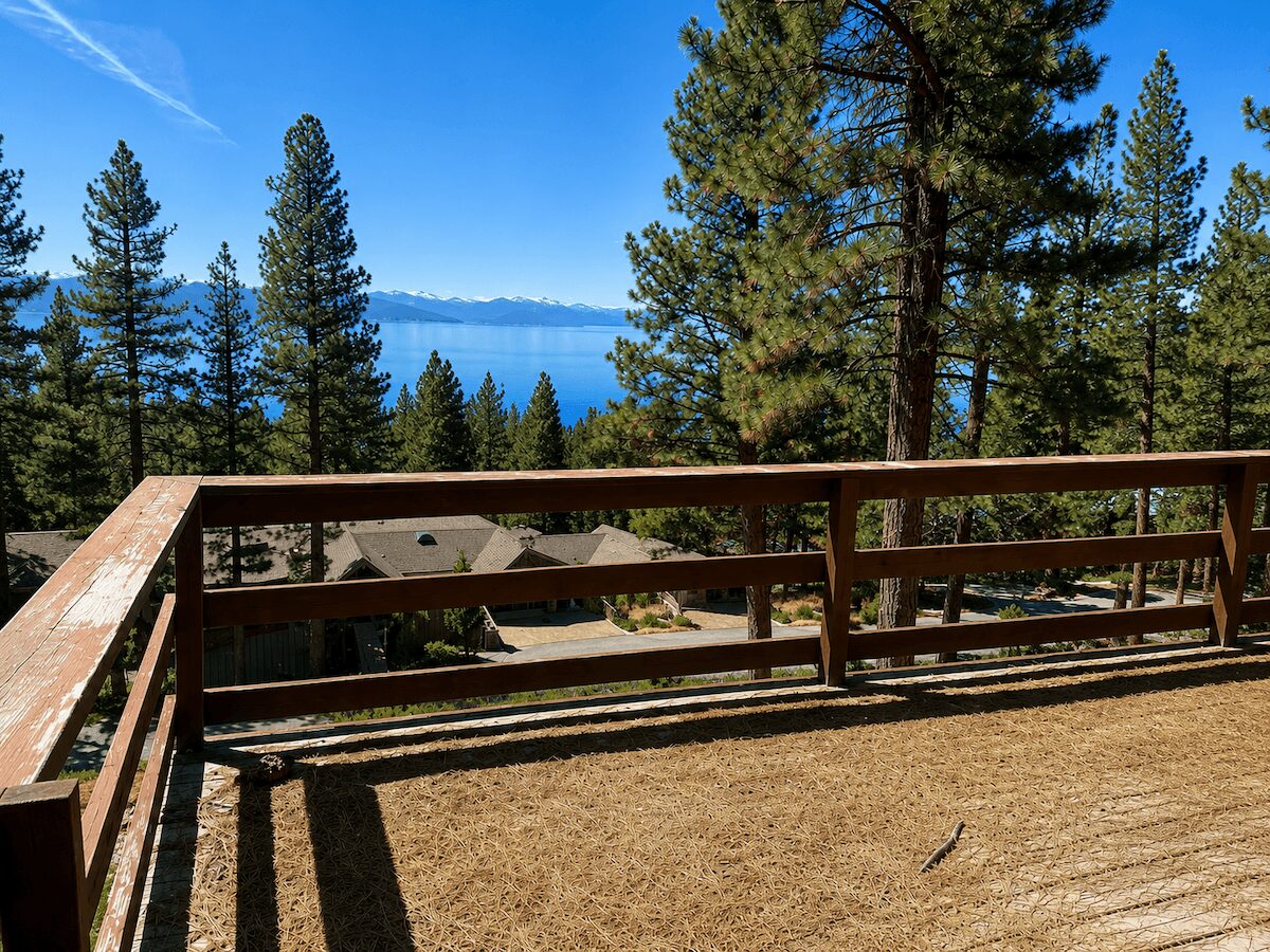 Wood deck covered in pine needles overlooking Lake Tahoe