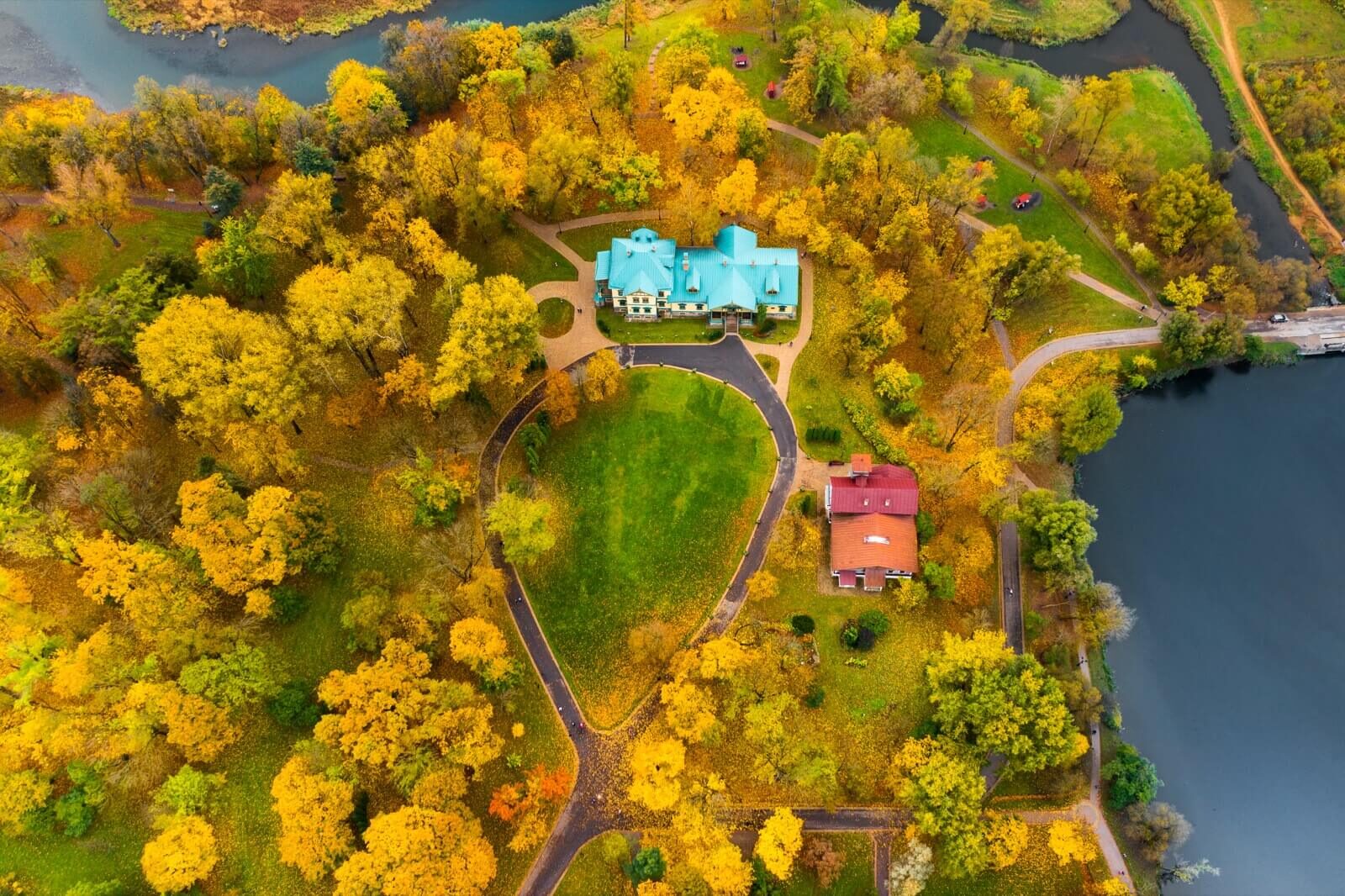 Aerial view of a large estate surrounded by autumn trees