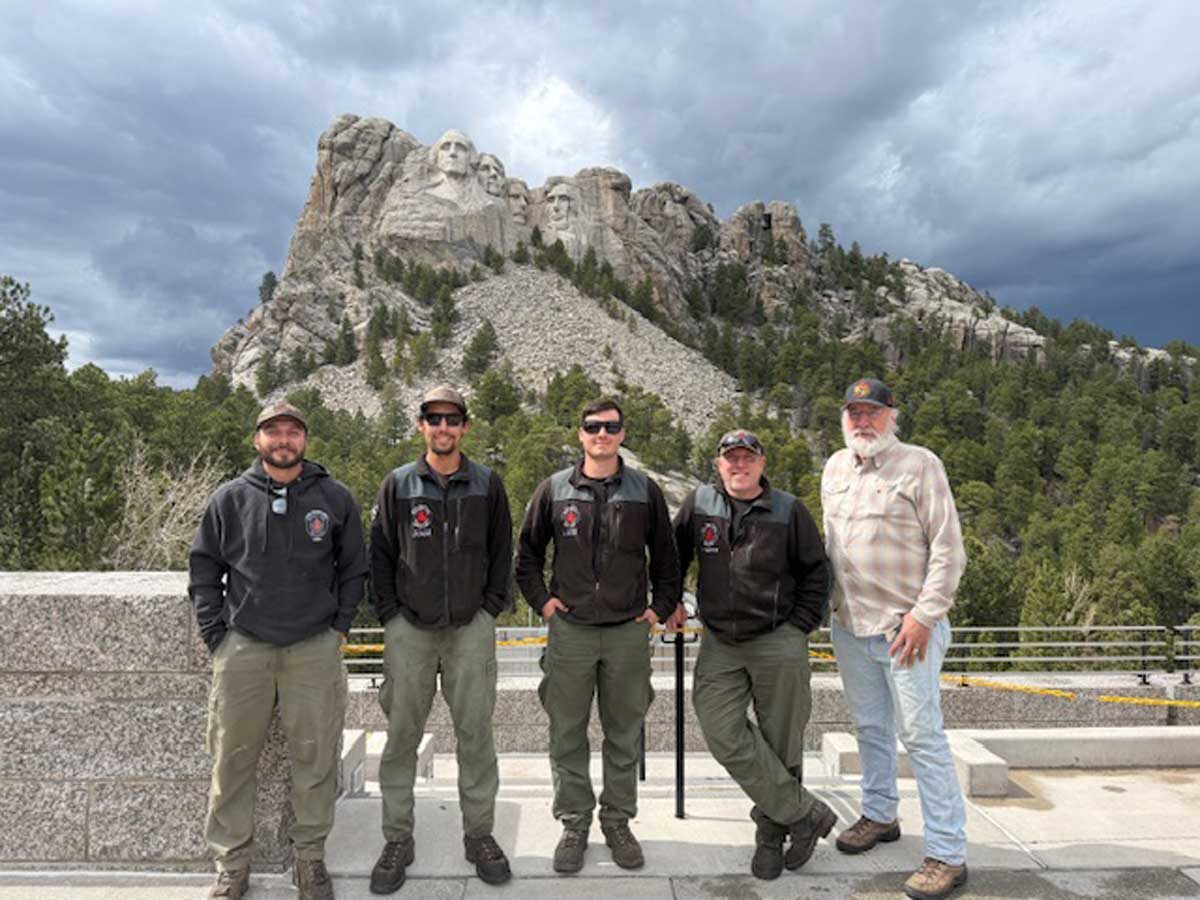 Frank Carroll with a crew in front of Mount Rushmore