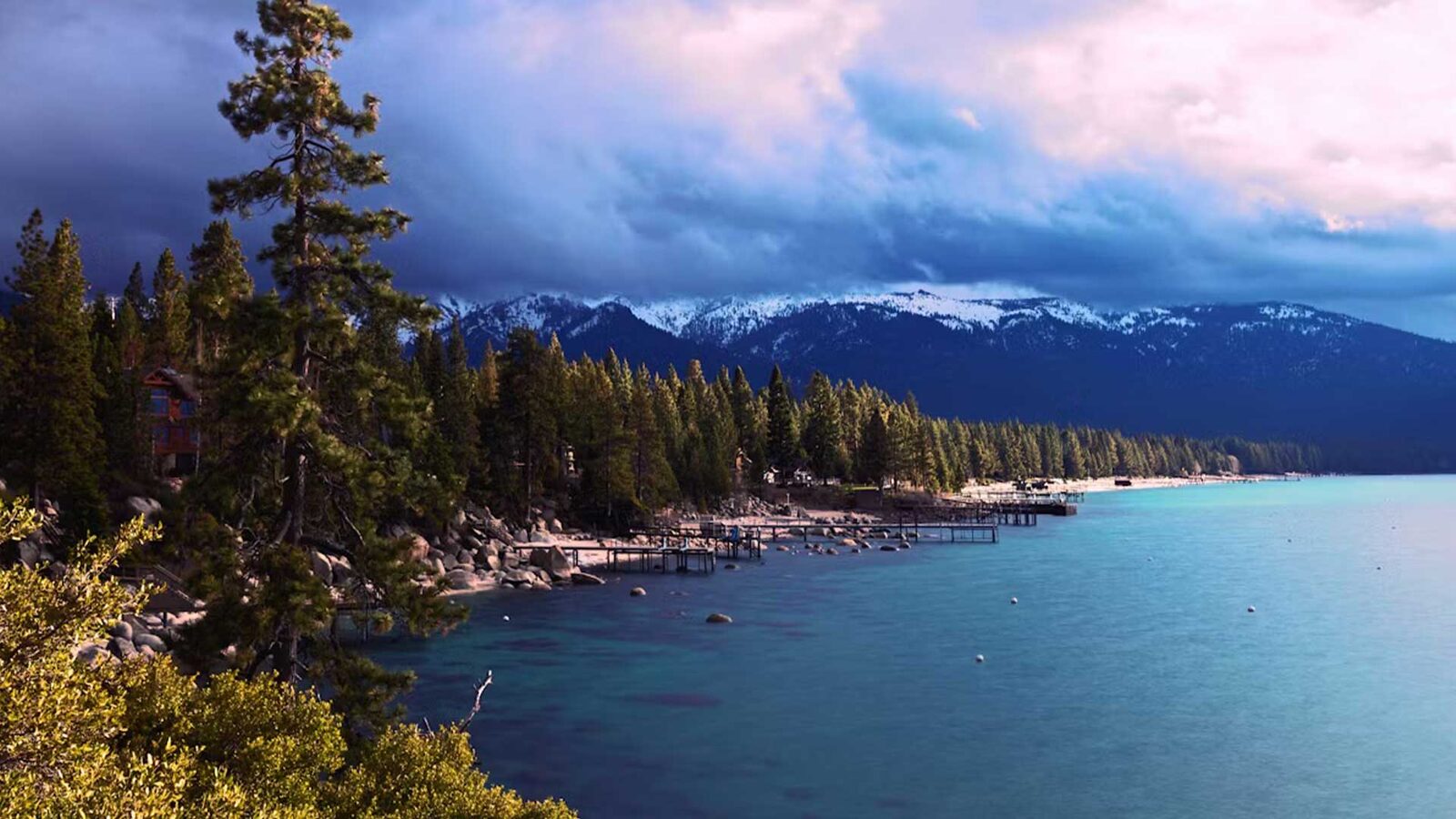 Lake Tahoe shoreline with snow-capped mountains